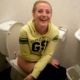 Some German girls record their friend using a toilet in a public restroom. We are not sure if she is peeing or pooping.